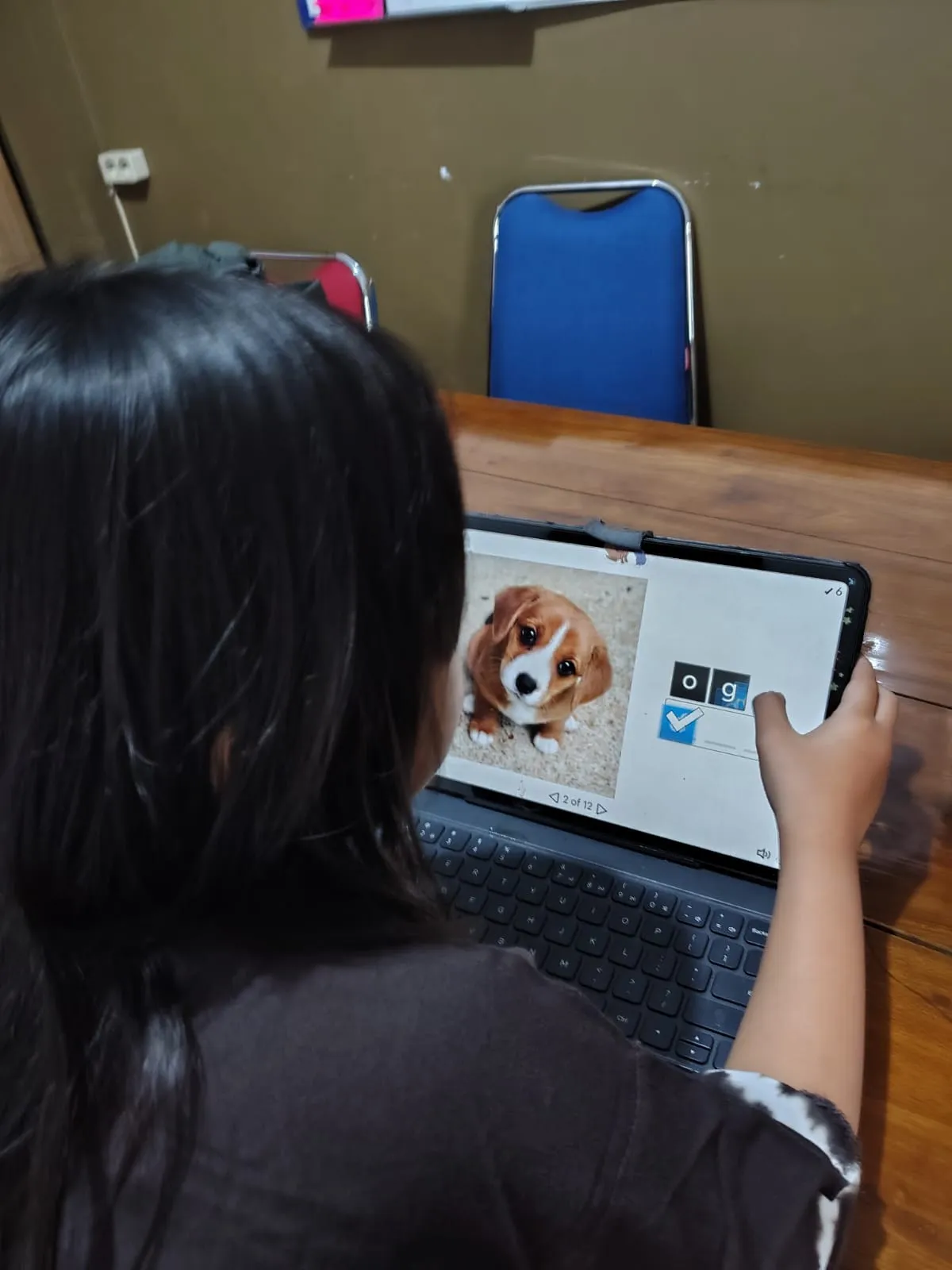 Anak mengikuti latihan phonics bahasa Inggris melalui tablet